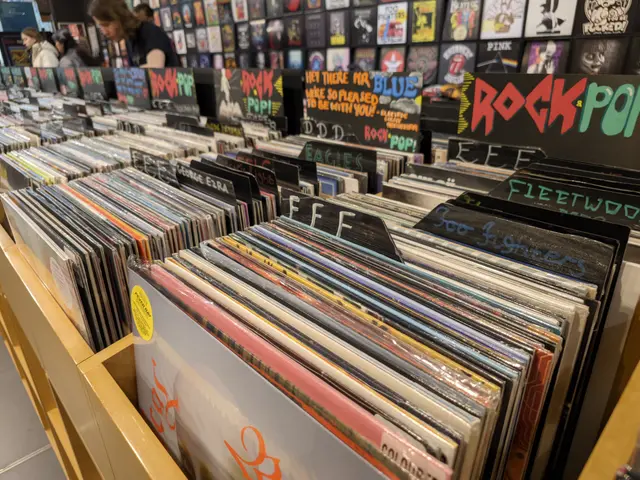 The image shows a record store filled with lots of vinyl records on display. There are a few people...