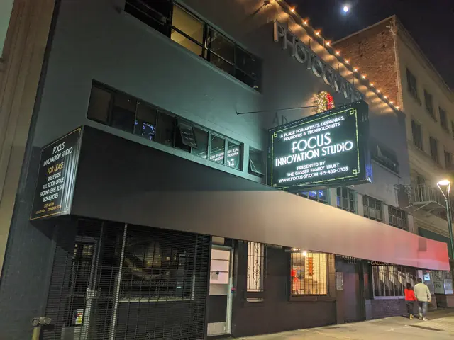 The image shows the Focus Innovation Studio in New York City at night, illuminated by street lights...