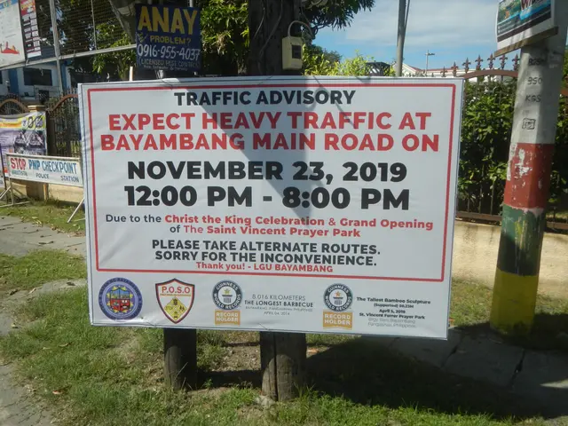 The image shows a sign on the side of a road that reads "Traffic Advisory: Expect Heavy Traffic at...