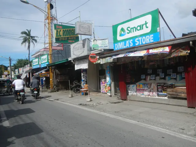 The image shows a bustling street scene with people riding motorcycles and cars driving down the...
