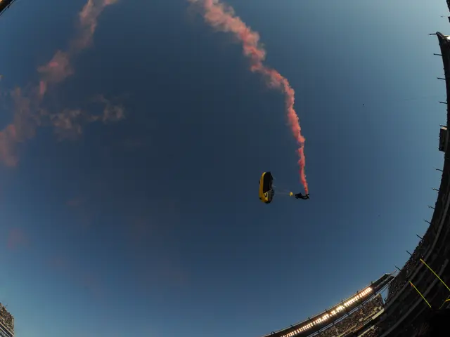The image shows a person flying through the air with a parachute, surrounded by a stadium with...