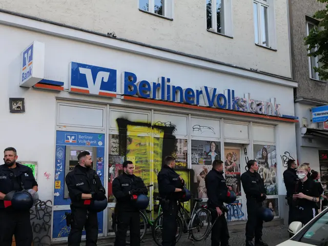 The image shows a group of police officers standing in front of a Berliner Volksbank, with some of...