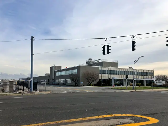 The image shows a large building with a lot of traffic lights on the side of it, surrounded by...