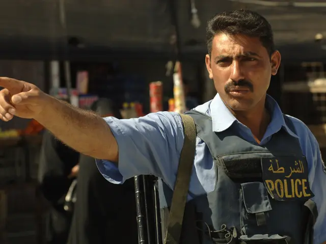 The image shows a police officer standing in front of a store, pointing at something. He is wearing...