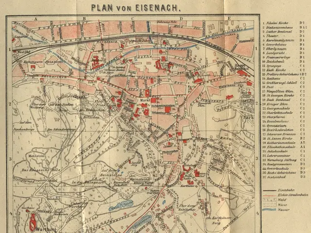 The image shows an old map of the city of Eisenach, Germany, with text on the paper. The map is...