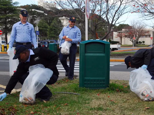 The image shows three police officers wearing caps and gloves, picking up trash on the side of the...