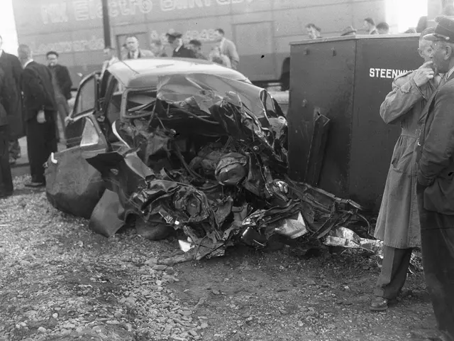 The image shows a black and white scene of a car that has been involved in a crash on the side of...