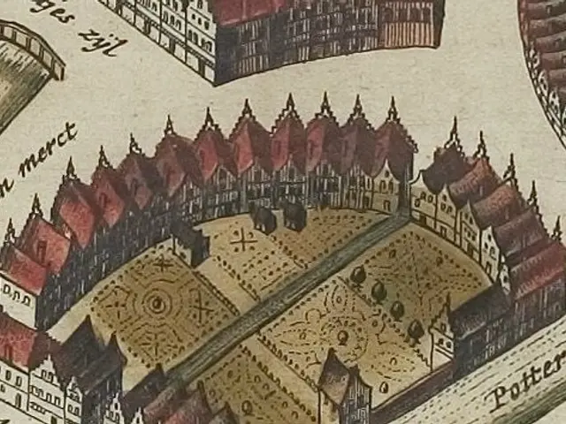 The image shows an old map of a city with a lot of buildings, including a castle, and text written...