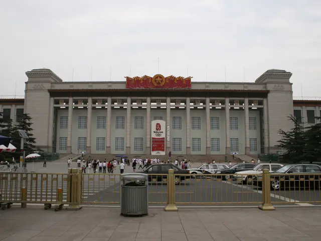 The image shows the Great Hall of the People in Pyongyang, North Korea. It is a large building with...