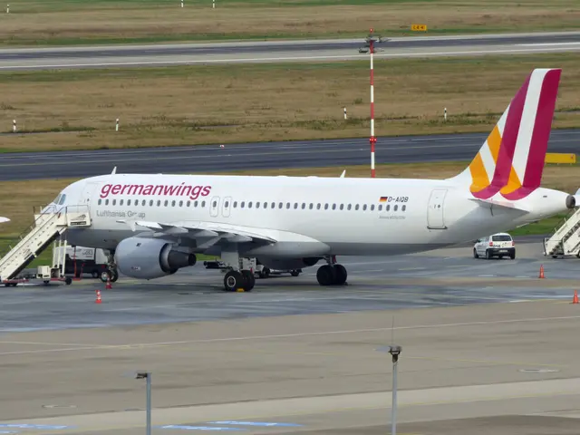 The image shows a Germanwings Airbus A320-200 at Frankfurt Airport, with vehicles on the road,...