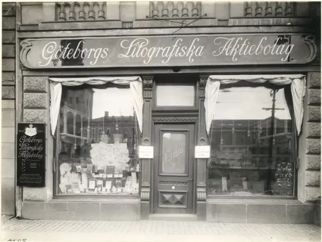 The image shows a black and white photo of a store front with a door, windows, curtains, and a...