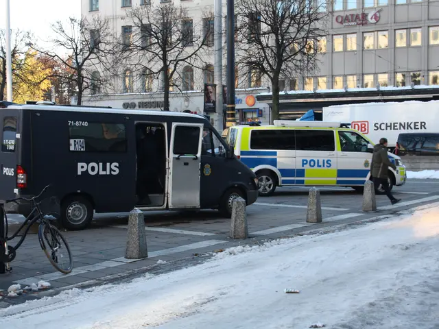 The image shows a police van parked on the side of a snowy street. There are vehicles on the road,...