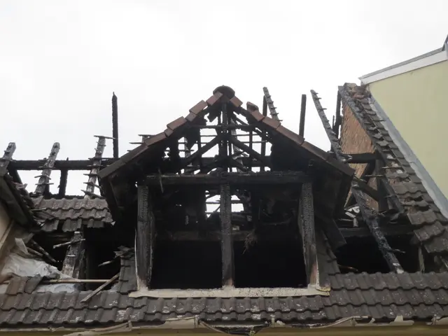 The image shows a building with a roof that has been destroyed by fire, with the sky in the...