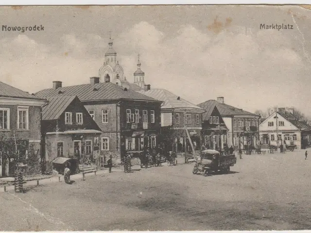 The image shows an old black and white photo of a city street with buildings, people, carts, poles,...
