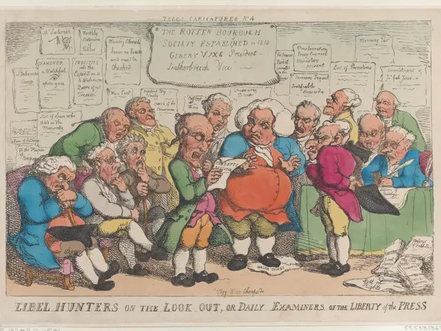 The image shows a group of people sitting around a table, with one person holding a paper in their...