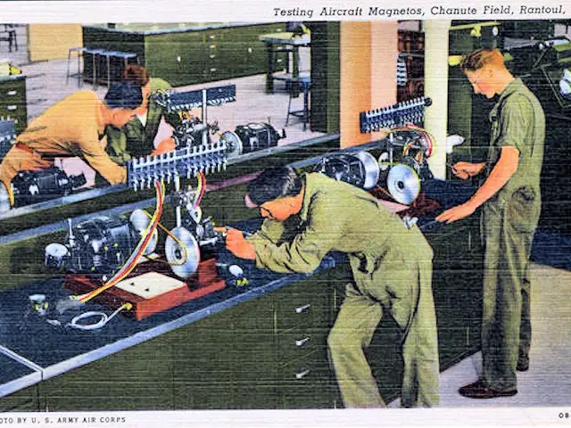 The image shows a group of men working on a machine in a factory. They are standing on the floor...