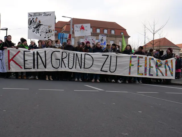 The image shows a group of people standing on the road, holding a banner that reads "Kein Grund zu...