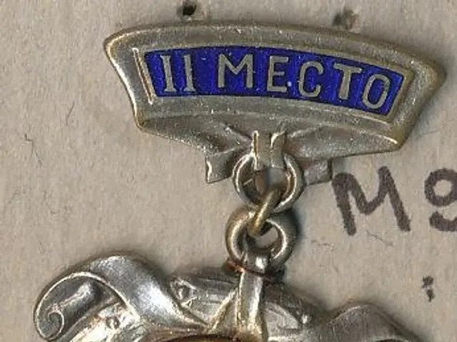 The image shows a silver medal with a blue and white emblem on it, which is a badge of the Soviet...