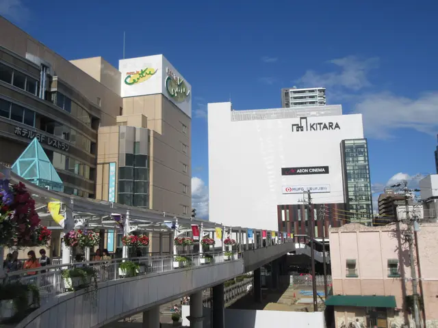 The image shows a bustling city street with tall buildings, a bridge with railings, pots with...
