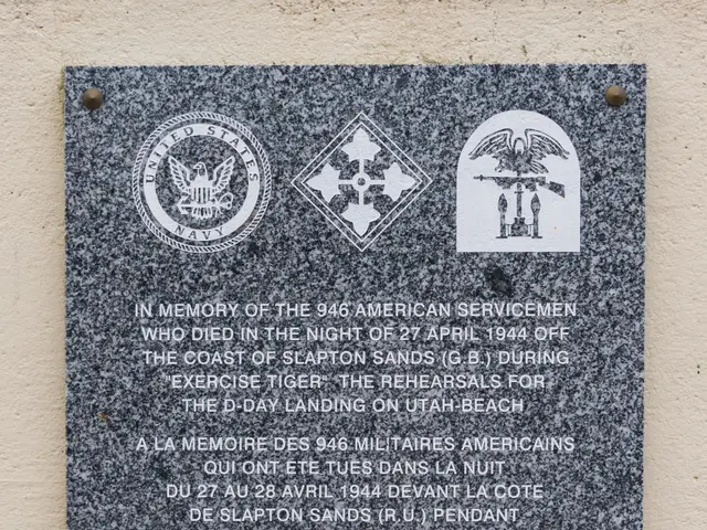The image shows a plaque on the side of a building that reads "In Memory of the 946 American...