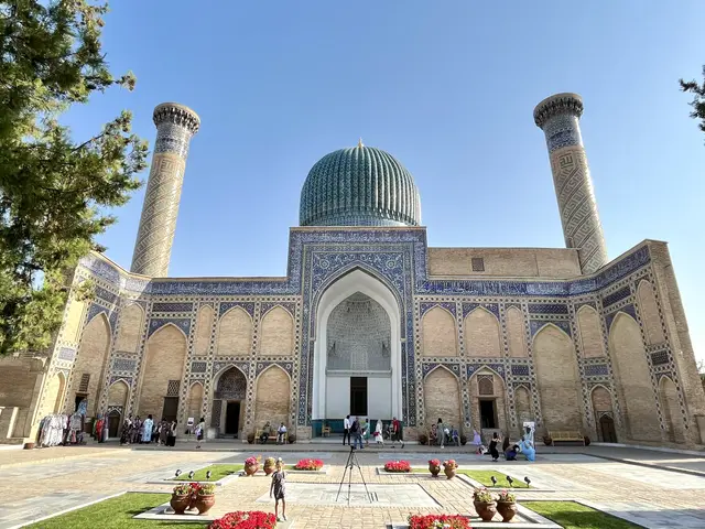 The image shows the Imam Mosque in Samarkand, Uzbekistan. It is a large building with a dome on...