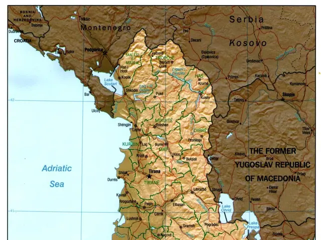 The image shows a poster of a political map of Albania, with text and a border around it. The map...