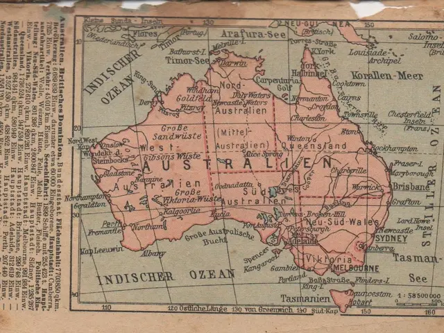 The image shows an old map of Australia on a piece of paper with text written on it. The map is...