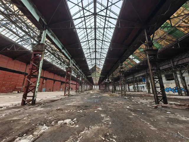 The image shows an abandoned building with a lot of debris on the ground, metal poles, a roof with...