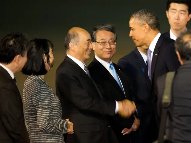 The image shows President Obama shaking hands with Japanese Prime Minister Shinzo Abe at the G20...