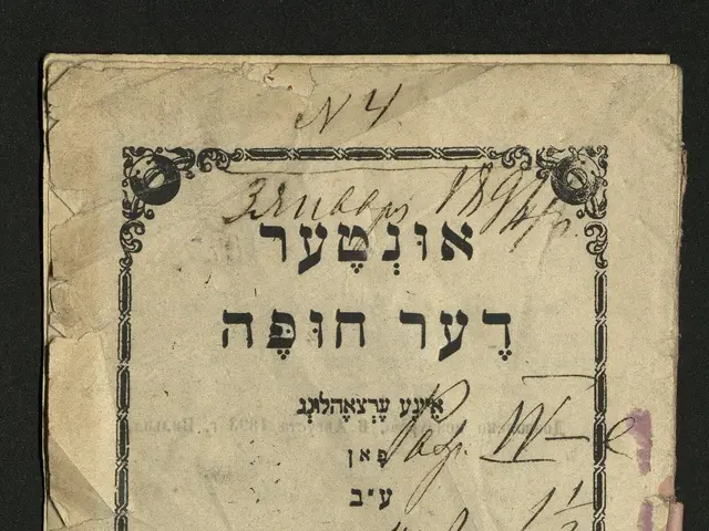 The image shows an old book with Hebrew writing on it against a black background. The text on the...