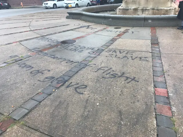 The image shows a sidewalk with graffiti on it in front of a building, surrounded by vehicles on...