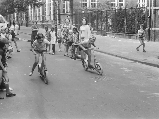 The image shows a group of children riding scooters down a street, with a car parked on the left...