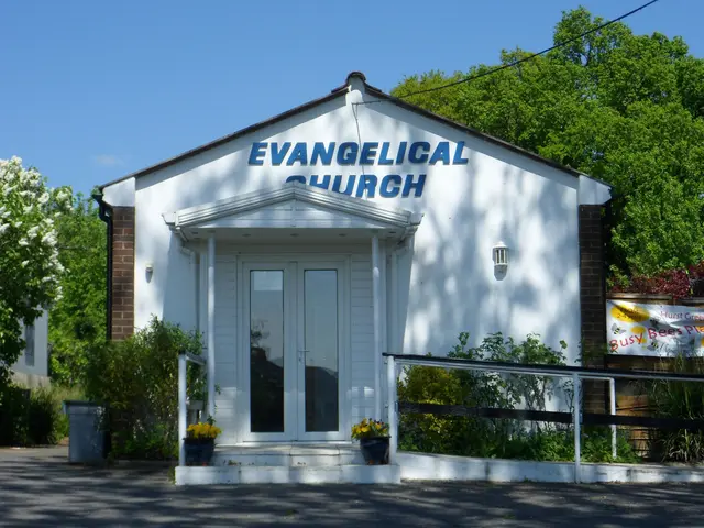 The image shows an evangelical church in the middle of a street, with a road at the bottom, plants...