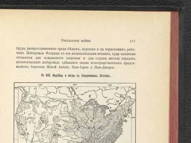 The image shows an open book with a map of the United States on it, placed on a black surface. The...