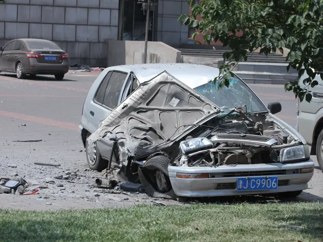 The image shows a car that has been involved in a crash on the side of the road, surrounded by...