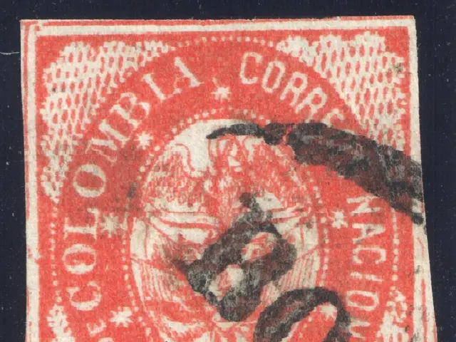 The image shows a red and black stamp with the words "Colombia" on it against a black background.