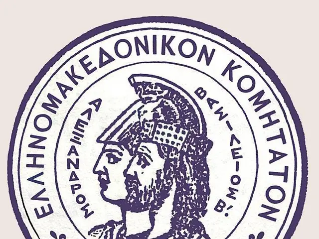 The image shows the seal of the Greek government, which features a picture of a person and text...