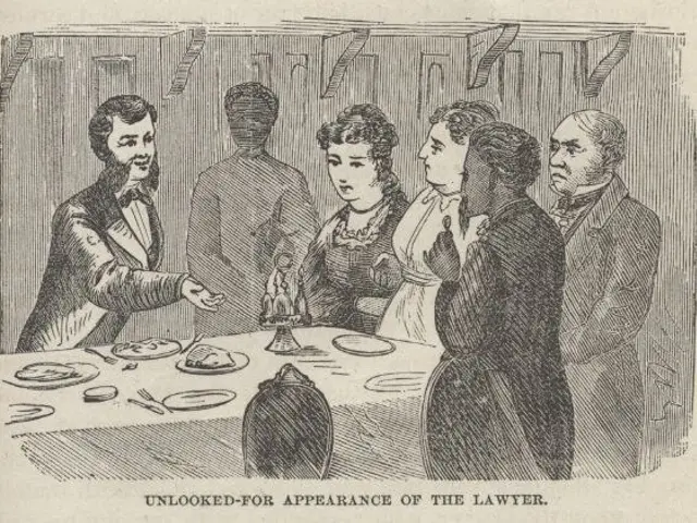 The image shows a group of people standing around a table with plates, spoons, forks, knives, and...