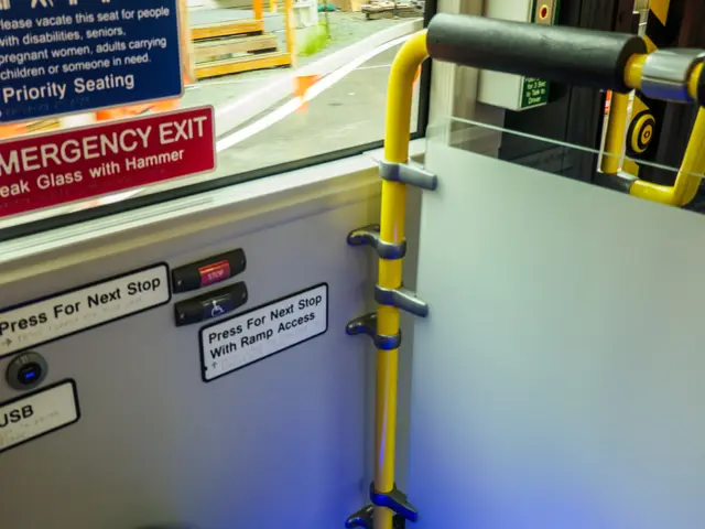 The image shows an emergency exit sign on the side of a train, with a door and handle in the...