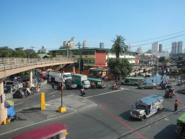 The image shows a bustling city street filled with lots of traffic, including cars, buses, and...