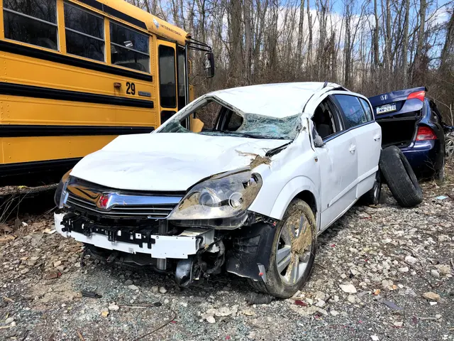 The image shows a white car that has been involved in a crash on the side of the road, with a...