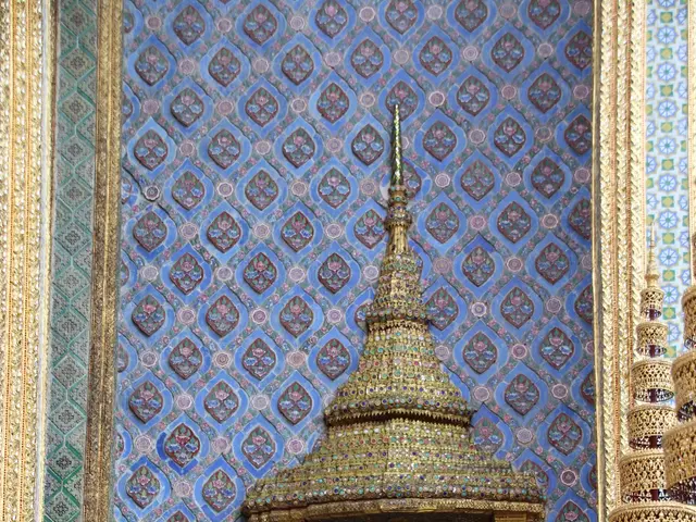 The image shows the grand palace in Bangkok, Thailand. At the bottom of the image, there is a...