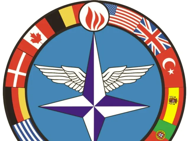 The image shows the logo of the NATO Joint Jet Pilot Training, which consists of a blue circle with...