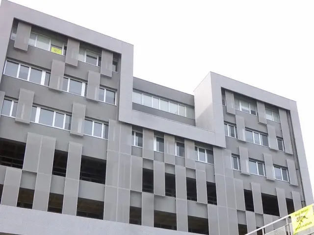The image shows a large building with a sign that reads "Refugees Welcome" in front of it,...