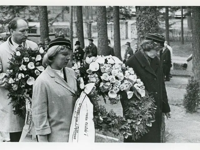 The image shows a group of people standing next to each other, each holding a bouquet of flowers....