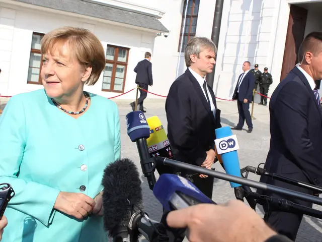 The image shows German Chancellor Angela Merkel speaking to reporters outside the Chancellery in...