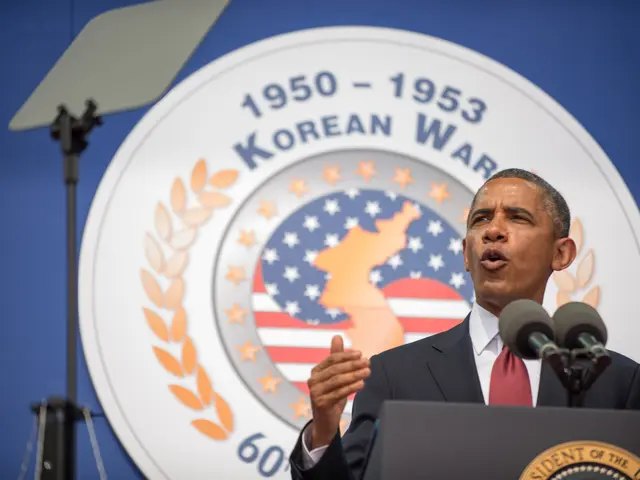 The image shows President Obama giving a speech at the Korean War Memorial in Washington, D.C. He...