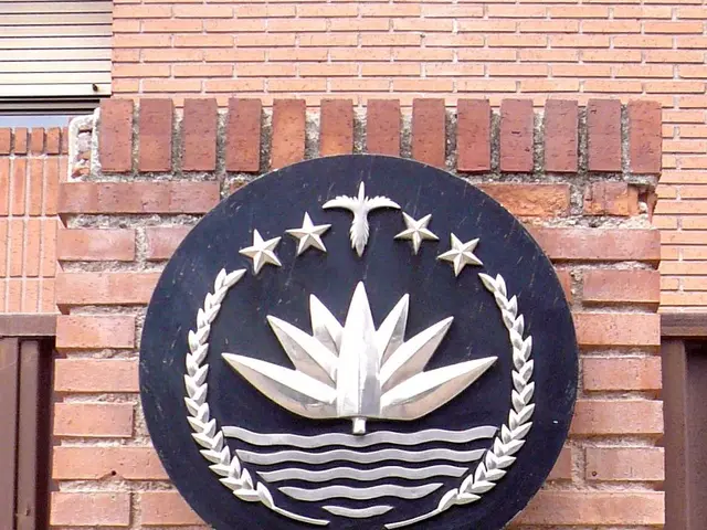 The image shows the Embassy of Bangladesh in Dhaka, Bangladesh, with a board on the wall displaying...
