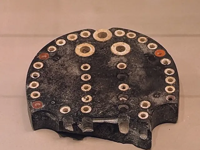 The image shows a close up of a metal object on a table, which appears to be a metal detector. It...
