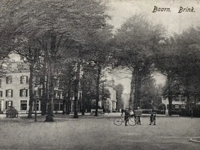The image shows a black and white photo of people riding bicycles in a park, surrounded by trees...